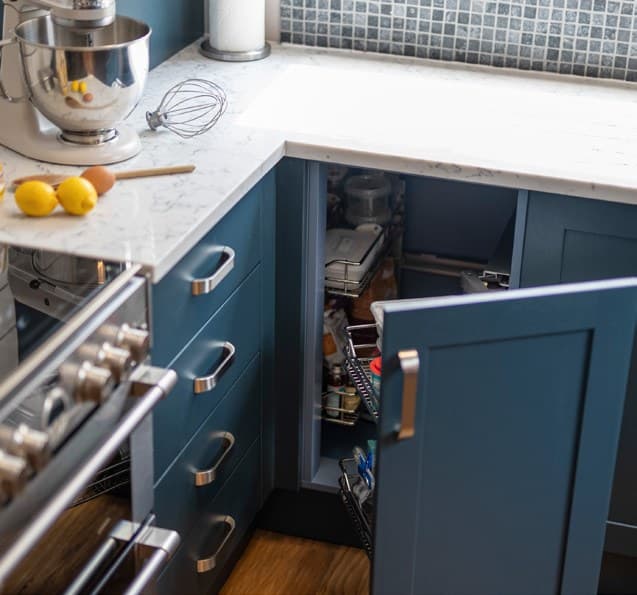 Pale worktop on navy blue kitchen cabinets